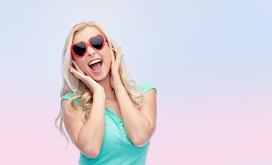 happy young woman in heart shape sunglasses