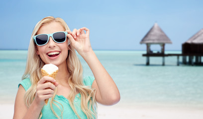 happy woman in sunglasses with ice cream on beach