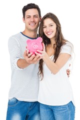 Couple holding piggy bank