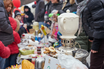 Samovar with teapot on school fair dedicated to russian traditional holiday Maslenitsa (Shrovetide) 