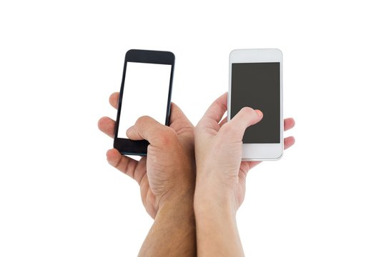 Hands of a couple holding smartphones