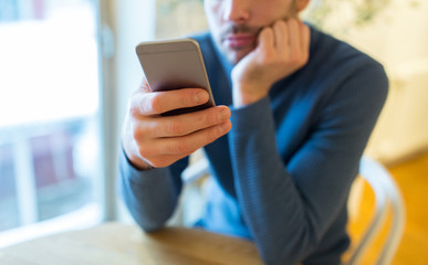 close up of man with smartphones at cafe