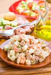 Russian salad in clay dish