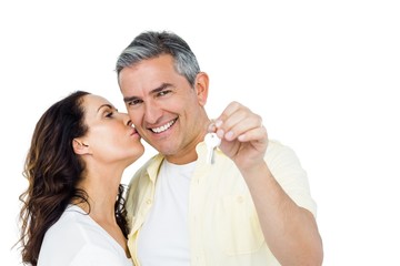 Portrait of happy couple holding home keys