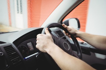 Close-up of hands holding steering wheel