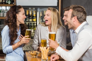 Friends laughing while drinking beer