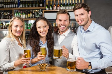 Friends toasting while looking at camera
