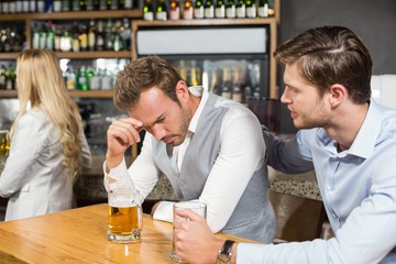 Tired man holding head in hand