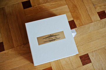 White leather wedding book or wedding album on wooden background