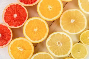 Fototapeta na wymiar Orange, Grapefruit, Lemon And Lime Citrus Fruit Slices On Table