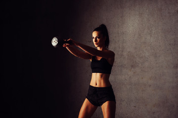 oung woman doing kettlebell swing exercise