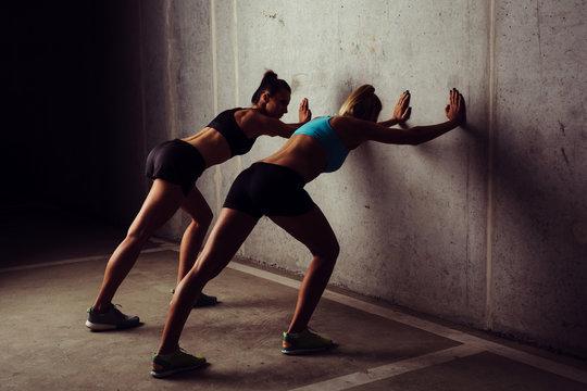 Two women stretching before workout
