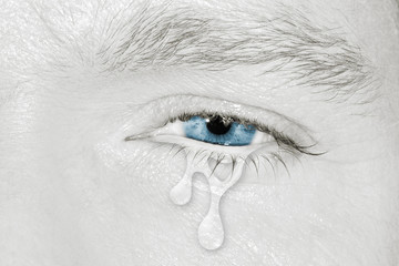 Crying blue eye on black and white face. concept of sadness, fear,love pains, mental depression disease,  eyewash and eye health 
