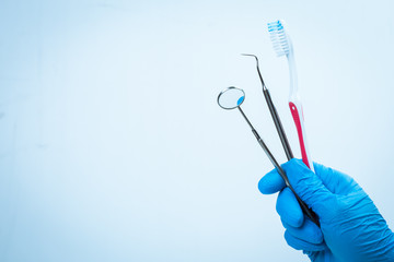 Dental tools in gloved hand