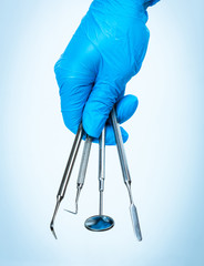 Dental tools in gloved hand