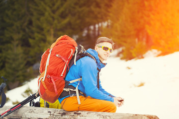 Man with backpack resting.