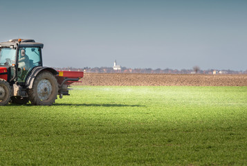  tractor fertilizing in field