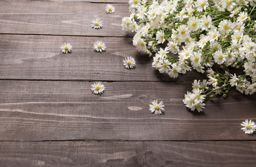 White cutter flowers are on the wooden background