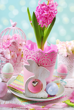 easter decoration with pink hyacinth in pot and wooden rabbit