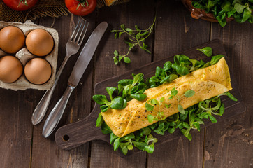 French omelet, fluffy, fresh eggs and herbs