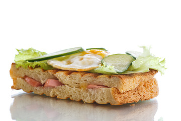 sandwich with sausage, cheese, lettuce and eggs