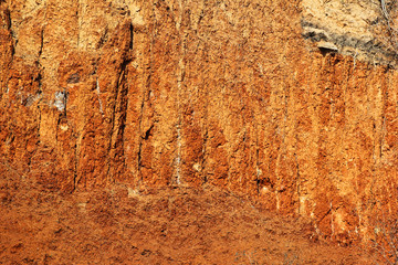 Eroded soil - red clay background