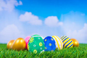 Easter Eggs on Fresh Green Grass over blue sky
