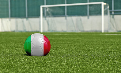 Soccer ball on the green field- flag Italy