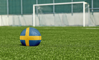 Soccer ball on the green field- flag Sweden