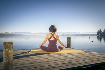 yoga woman sitting lake