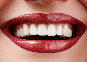 Beautiful smile with whitening teeth. Dental photo. Perfect fashion lips makeup. Health happy female smile. Macro close-up shot of woman's mouth. Care about tooth
