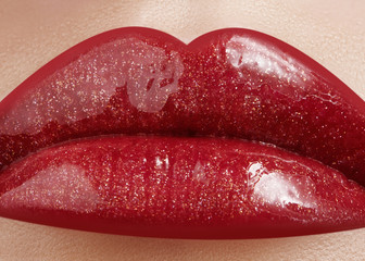 Close-up of female lips with bright makeup. Macro of woman's face. Fashion lip make-up with red gloss