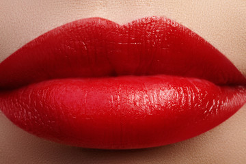 Close-up of woman's lips with fashion red make-up. Beautiful female mouth, full lips with perfect makeup. Classic visage. Part of female face. Macro shot of beautiful make up on full lips.