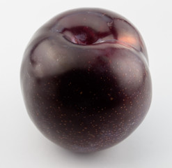 Single plum on whie