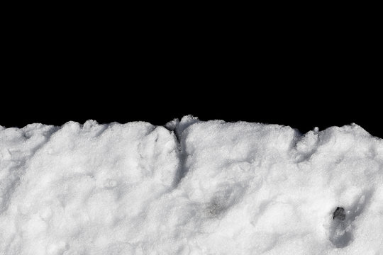 Pile of snow isolated on black