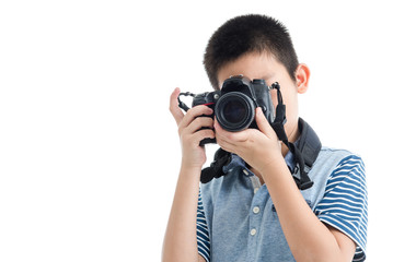 Asian boy holding camera on white background.