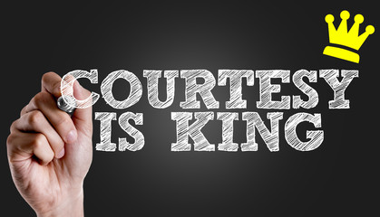 Hand writing the text: Courtesy is King