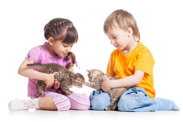 Kids girl and boy playing with kittens