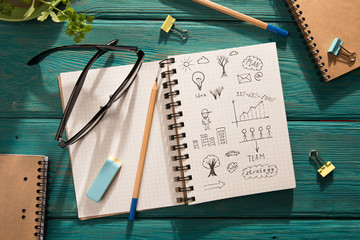 business concept - notepad with sketch on the desk