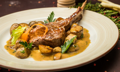 Grilled lamb served on white plate with vegetables