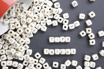 Tips and Tricks  word written on wood block. Wooden ABC