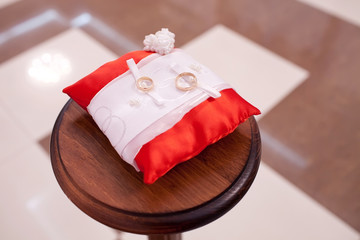 Engagement gold rings on the pillow