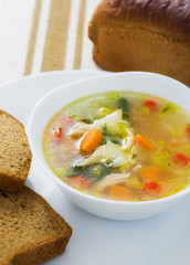Vegetable soup with chicken breast in bowl
