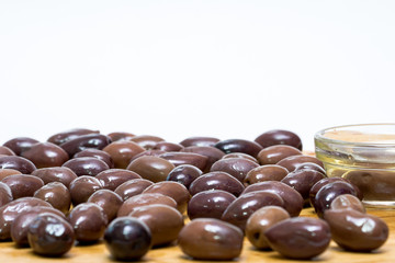 Olive olive oil on a wooden board, and lettuce isolated
