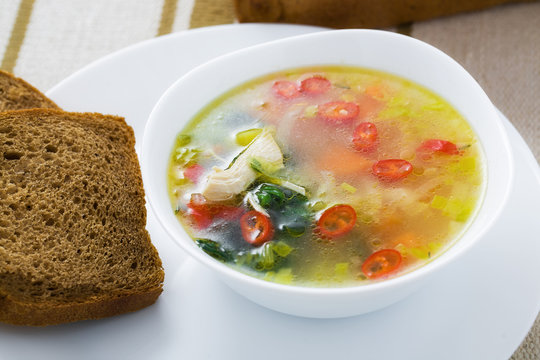 Vegetable soup with chicken breast in bowl
