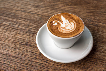 hot coffee with latte art in swan shape