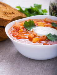 Vegetarian borsch with sour cream and parsley
