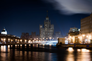 Fototapeta na wymiar View from another side of the river to the hillock or skyscraper on the Kotelnicheskaya embankment in the night