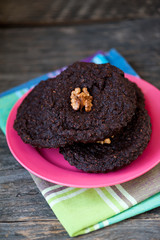 Round homemade brownies with walnuts on a rustic background