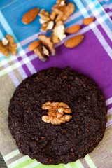 Round homemade brownies with walnuts on a rustic background